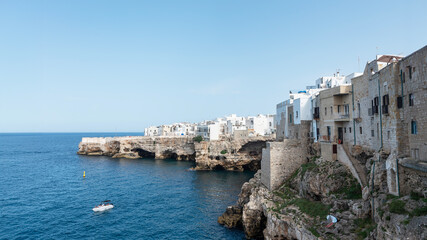 Polignano a mare, white and perched on a cliff overlooking a dream inlet.