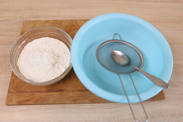 Flour and utensils for preparing dough.