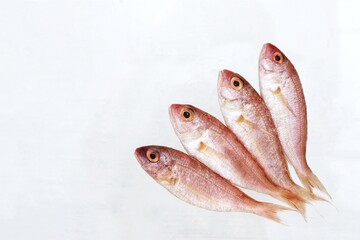 Four mullet fish, on the table, fresh sea fish, copy space, top view, background