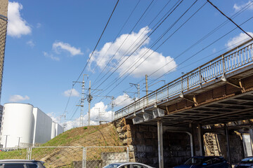 A bridge over a road with a train crossing over it