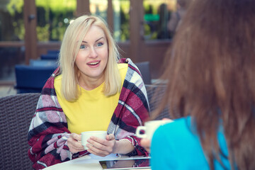 Young woman is surprised to hear the news her friend told her.