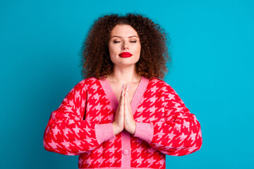 Photo of shiny dreamy lady dressed red cardigan praying closed eyes isolated blue color background