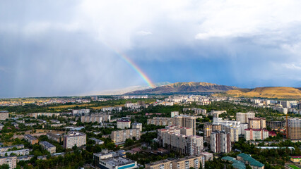 Bishkek with rainbow and distant mountains