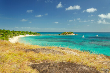 Picturesque tropical sandy Anchor Beach with turquoise water on Lizard Island. Lizard Island  is located on Great Barrier Reef in north-east part of Queensland, Australia