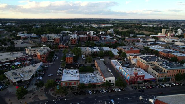 Aerial Drone Flyover of Downtown Fort Collins Colorado at sunset on a summer night.