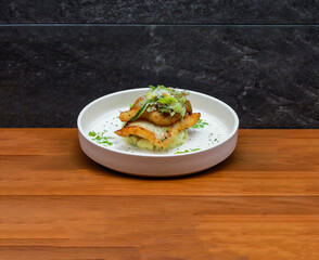 Halibut and Leek with spring onion and coriander served in dish isolated on wooden table side view of italian fastfood