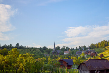 landscape with different traditional houses from Maramures, Romania, Houses built predominantly from wood.