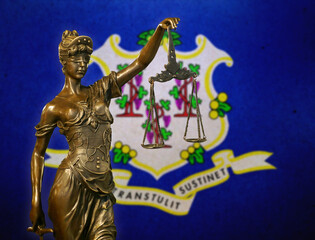 Lady Justice before a flag of Connecticut