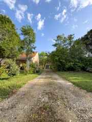 path or road in countryside leads to village