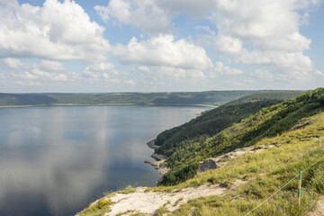 Shores of the Dniester River with cloudy sky. Bakota, Ukraine