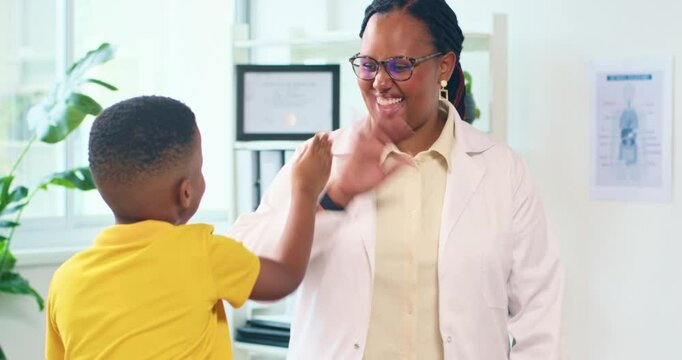 Pediatrician High Fives Young Boy Patient