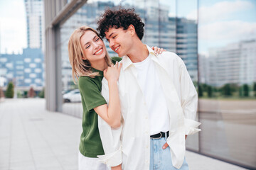 Smiling beautiful woman and her handsome boyfriend. Couple in casual summer clothes. Happy cheerful family. Female and man having fun. They posing in the street in sunny day. Having tender moments