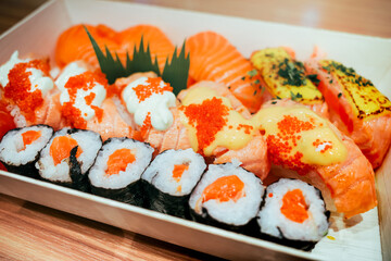 Close-up plate of delicious assorted Japanese salmon sushi with flying fish roe and mayonnaise