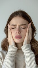 portrait of a woman with migrane, holding her head in pain