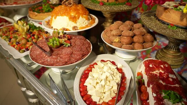 festive table with cheeses, pies, breads and salami
