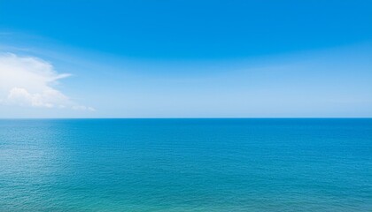 Obraz premium Tranquil view of calm sea against blue sky during summer