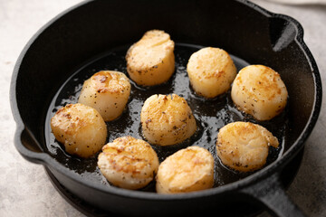 cooking sclallop on iron skillet pan