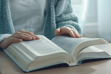 Close-up of a person reading an open book, immersed in a peaceful and quiet study environment.