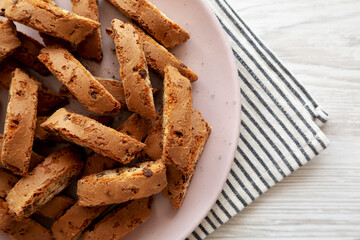 Homemade Cantuccini Cookies with Chocolate Chips on a Plate, top view. Copy space.
