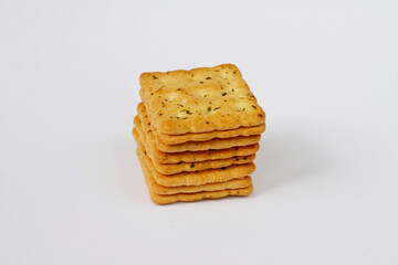 Cracker biscuit with a sprinkle of seaweed on White background.