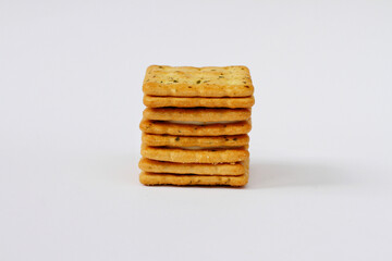 Cracker biscuit with a sprinkle of seaweed on White background.