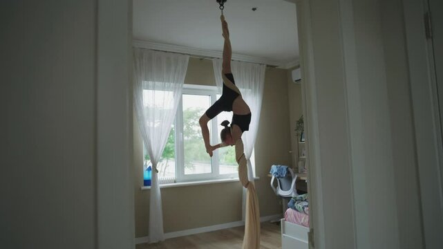 Caucasian Teenager Spins On Aerial Gymnastic Ribbons In Middle Of Bedroom. Young Girl Exercises In Air Gymnastic In Her Room At Home. Teen Diligently Trains And Spends Weekend At Home. Slow Motion.