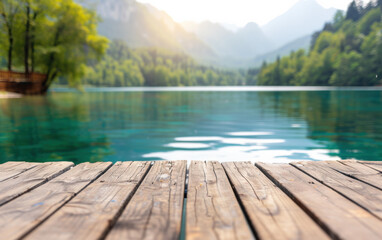 Tranquil wooden dock overlooking a serene lake surrounded by lush green forest and majestic mountains, bathed in soft morning light.