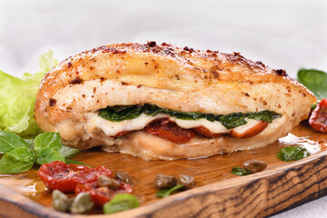 Baked chicken breast with spinach, sun-dried tomatoes and mozzarella
