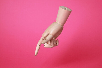 Wooden hand model on pink background. Mannequin part