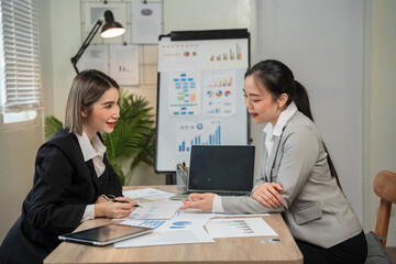 Asian business, women Talk about new projects, presents at home office.