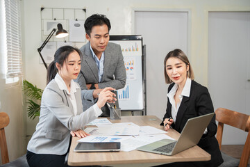 Asian businessmen, women and men Talk about new projects, presents at home office.