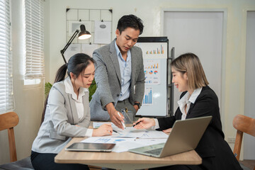 Asian businessmen, women and men Talk about new projects, presents at home office.