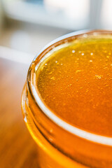 Honey Jar with Sweet Bee Honey Freshly Extracted and Harvested Filled to the Brim of the Glass