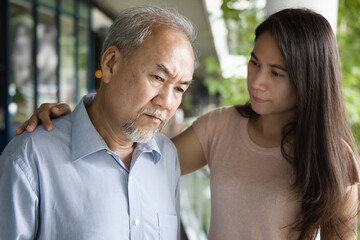 Middle aged woman daughter taking care of her senior father suffering from Alzheimer's disease,...