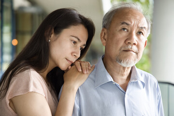 Middle aged woman daughter taking care of her senior father suffering from Alzheimer's disease, memory loss, dementia, mental degeneration, world Alzheimer’s day concept image
