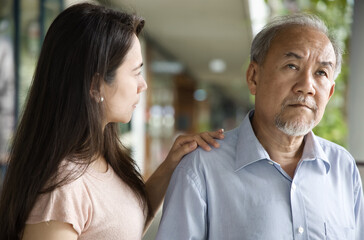 Middle aged woman daughter taking care of her senior father suffering from Alzheimer's disease, memory loss, dementia, mental degeneration, world Alzheimer’s day concept image