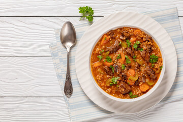 beef barley soup in a bowl, top view