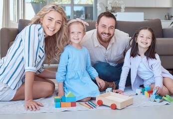 Parents, kids and toys in portrait on floor with smile, play and learning with blocks for problem solving. Father, mother and daughter children on carpet with bonding, care and love in family house