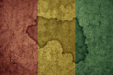 map and flag of guinea on a old vintage crack paper background .