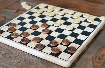 wooden checkers on a wooden chessboard