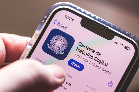Closeup de um homem segurando um smartphone e mostrando o aplicativo da Carteira de Trabalho digital. Brasil - 19 de Julho de 2024.