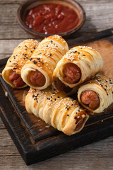 Homemade Sausage in dough rolls on plate . Hot dog Top view