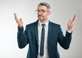 Businessman, portrait and confused in studio for choice with questions, dont know and uncertain for why. Male entrepreneur, shrug and doubt for decision, palm scale and option by white background