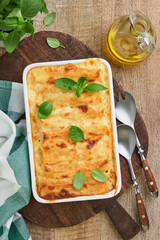 Italian cannelloni. Pasta casserole cannelloni with ground chicken, tomato and bechamel sauce. Traditional Italian pasta dish and recipe. Cover or article. Top view. Place for text.