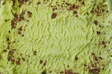 Pistachio ice cream detailed macro texture. Texture pistachio ice cream with chocolate chips. Top view. Food concept. Blank for design.