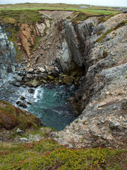 The "Dungeon" at Dungeon Provincial Park, located on the Bonavista Peninsula in Newfoundland, Canada, and recognized as a UNESCO Global Geopark Geosite, was created through the collapse of a sea cave.