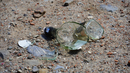 A broken glass beer bottle on the floor