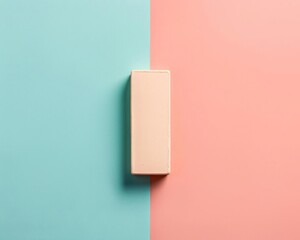Fototapeta premium Minimalist rectangular cream-colored box on a pastel pink and blue split background, showcasing modern and simple packaging design.