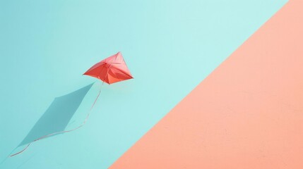 A red kite flying in the clear blue sky with its shadow casting on a minimalistic background featuring soft pastel colors.