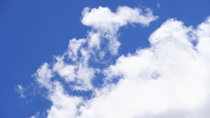 Skyscape of white clouds in the blue sky